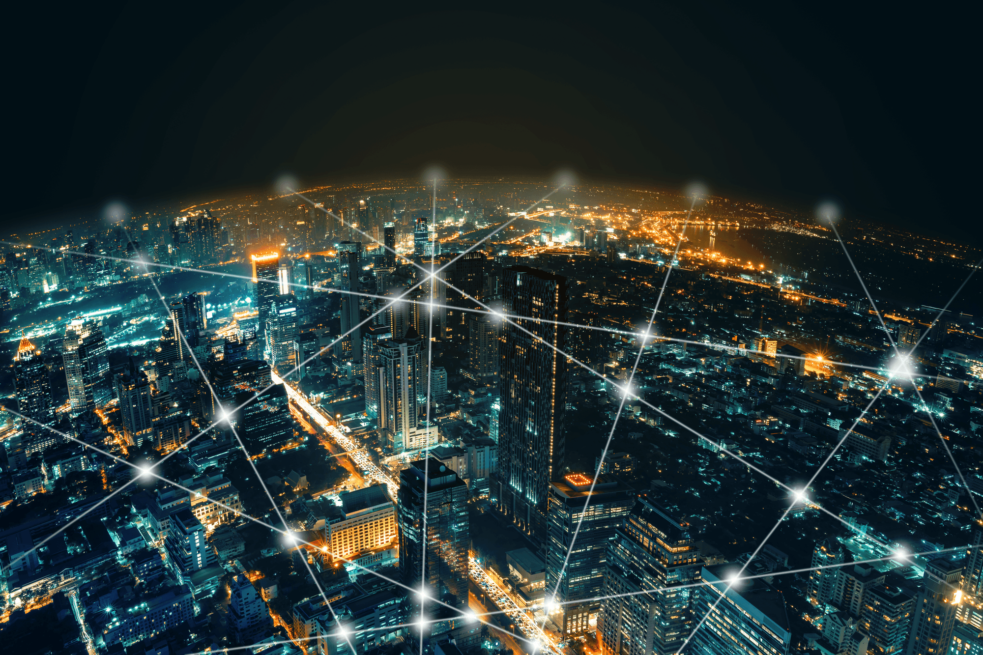Support specialists collaborating with digital network visualization over a cityscape at night