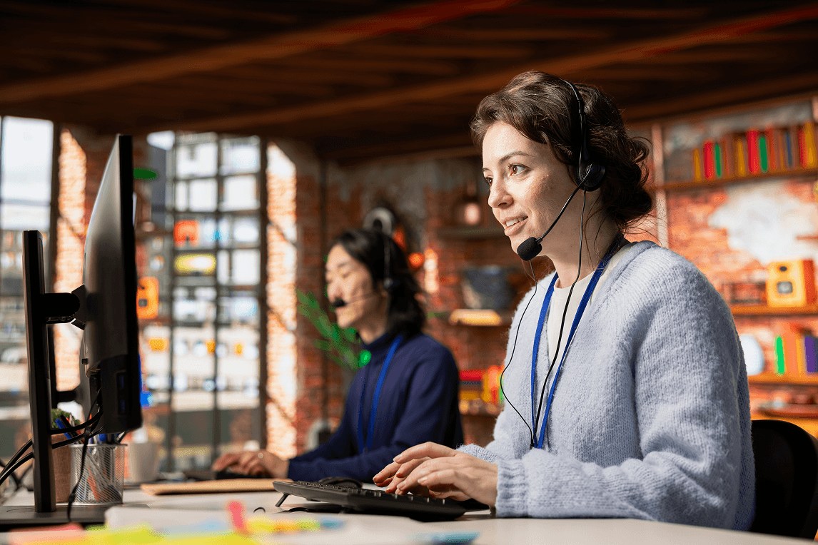 Technical support specialists with headsets in a modern office